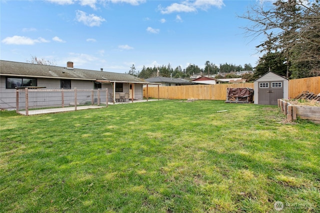 view of yard featuring a fenced backyard, a storage unit, and an outdoor structure