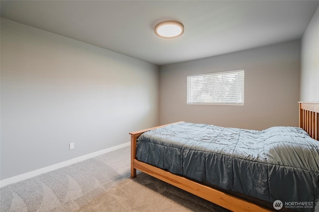 carpeted bedroom featuring baseboards