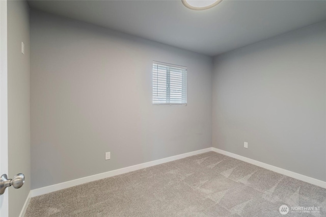 unfurnished room with baseboards and light colored carpet