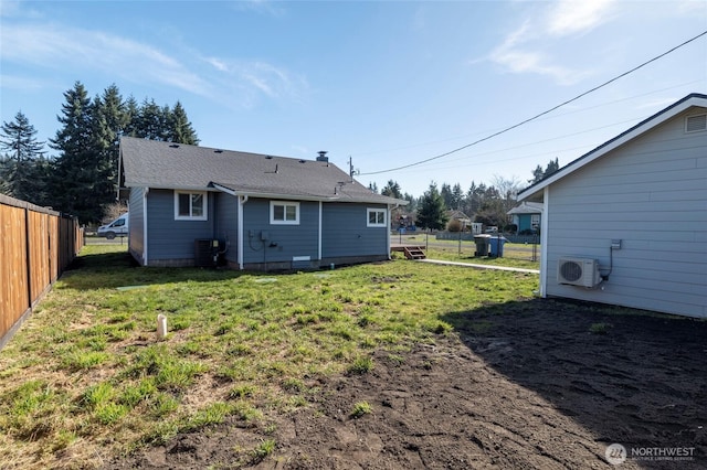 rear view of property with a yard, ac unit, cooling unit, and fence