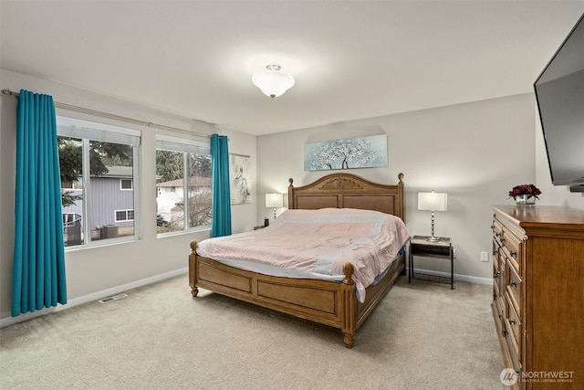 bedroom featuring light carpet, visible vents, and baseboards