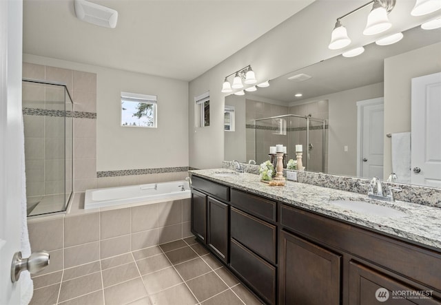 bathroom with a garden tub, a sink, a shower stall, tile patterned floors, and double vanity