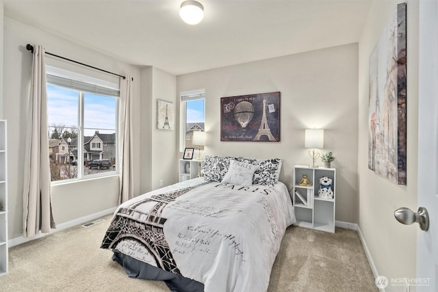 carpeted bedroom featuring multiple windows, visible vents, and baseboards