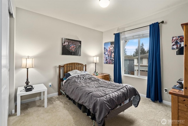 bedroom with carpet floors and baseboards