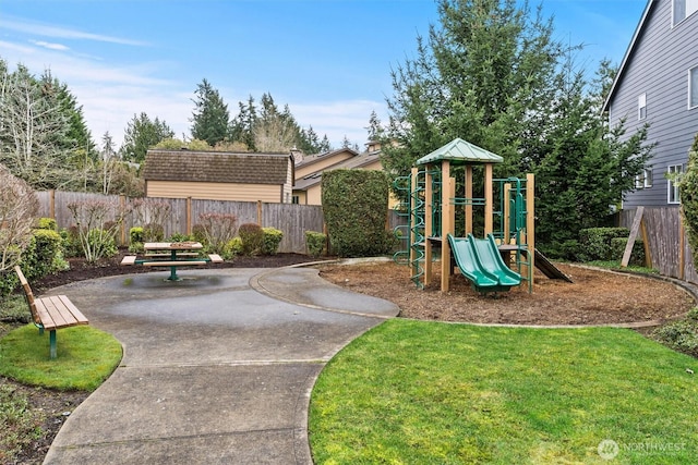 view of jungle gym with a yard, a patio area, and fence