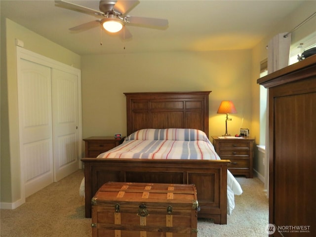 bedroom featuring baseboards, a ceiling fan, a closet, and light carpet