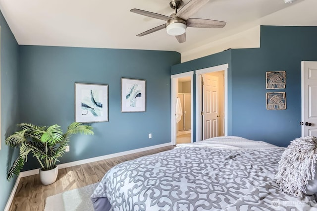 bedroom featuring ceiling fan, baseboards, and wood finished floors