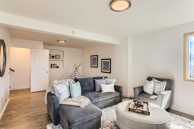 living area with light wood-style flooring and baseboards