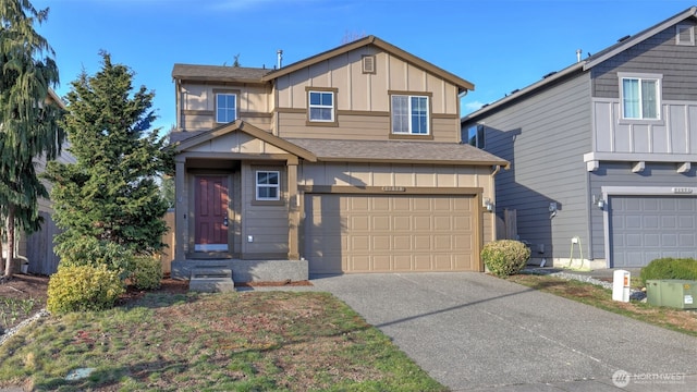 view of front of property with a garage, roof with shingles, board and batten siding, and concrete driveway