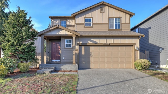 view of front facade featuring roof with shingles, board and batten siding, concrete driveway, and an attached garage