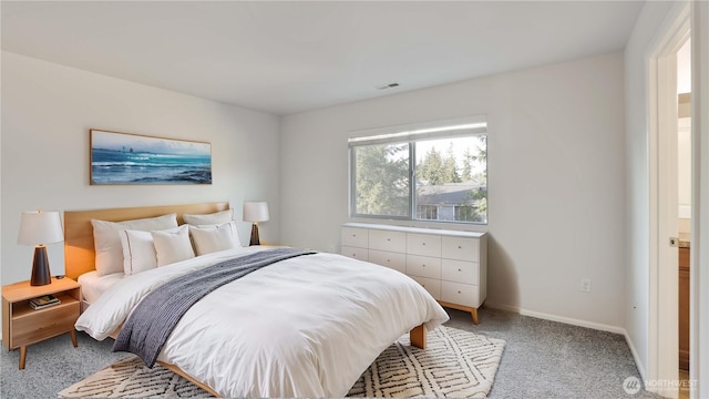 bedroom featuring visible vents, baseboards, and light colored carpet