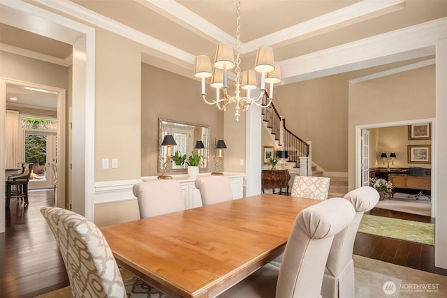 dining room with a chandelier, stairway, ornamental molding, and dark wood-style flooring