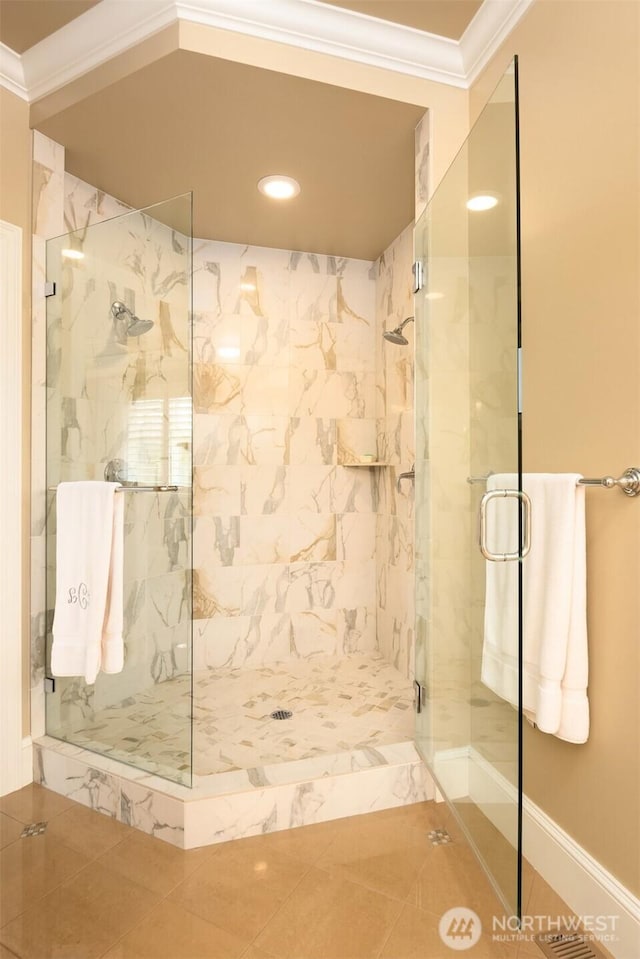 bathroom featuring a marble finish shower and crown molding