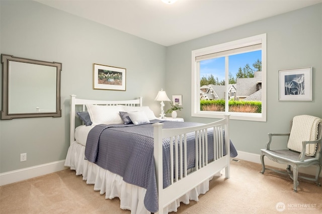 carpeted bedroom featuring baseboards