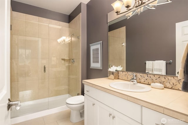 full bathroom with vanity, a shower stall, toilet, and tile patterned floors