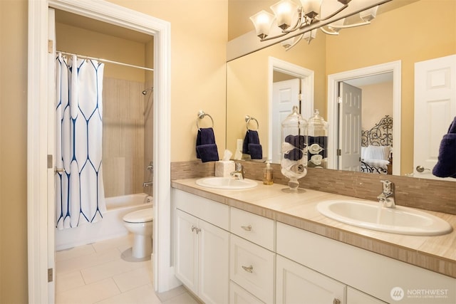 full bathroom featuring a sink, washtub / shower combination, toilet, and double vanity