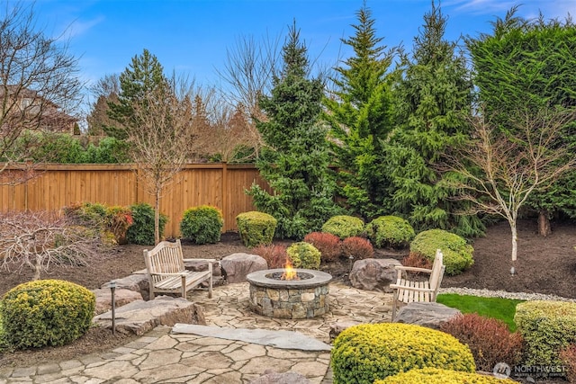 view of patio featuring an outdoor fire pit and fence