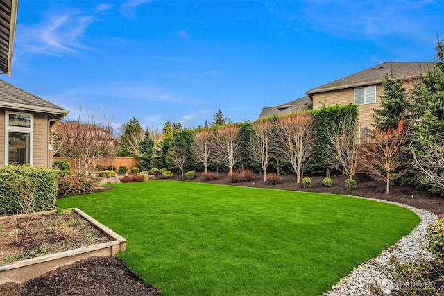 view of yard with a vegetable garden and fence