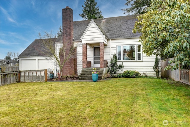 view of front of house featuring a garage, a shingled roof, fence, a chimney, and a front yard