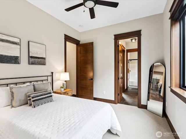 bedroom featuring baseboards, carpet floors, ensuite bath, and a ceiling fan