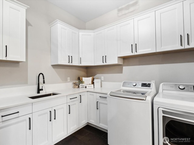 laundry area featuring a sink, cabinet space, and washing machine and dryer