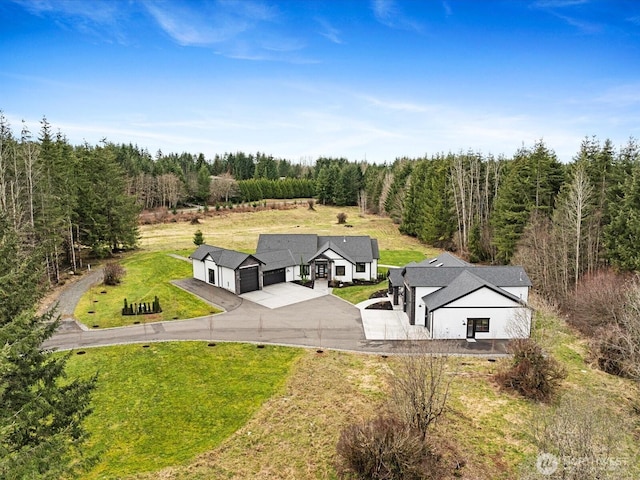 birds eye view of property with a wooded view