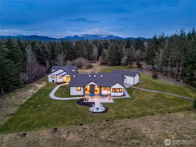 drone / aerial view with a mountain view and a forest view