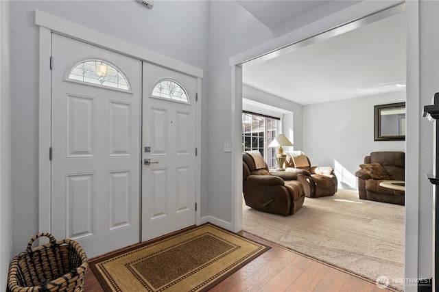 foyer with hardwood / wood-style flooring and baseboards