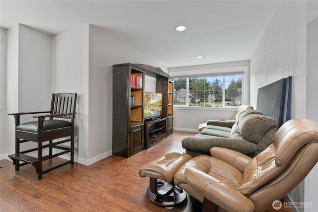 living room with recessed lighting, baseboards, and wood finished floors