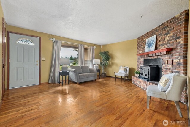 living room featuring a textured ceiling and wood finished floors