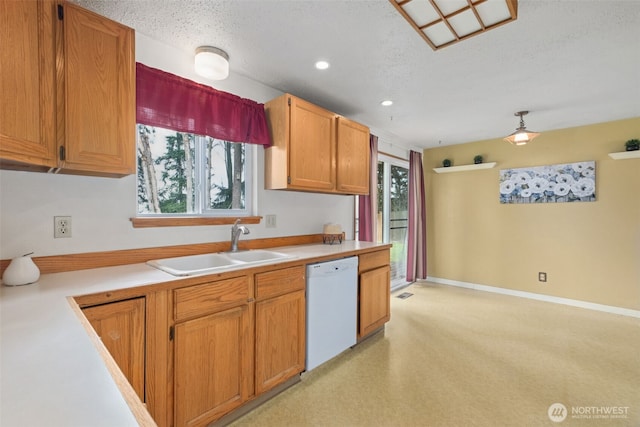 kitchen with baseboards, a sink, light countertops, a textured ceiling, and dishwasher