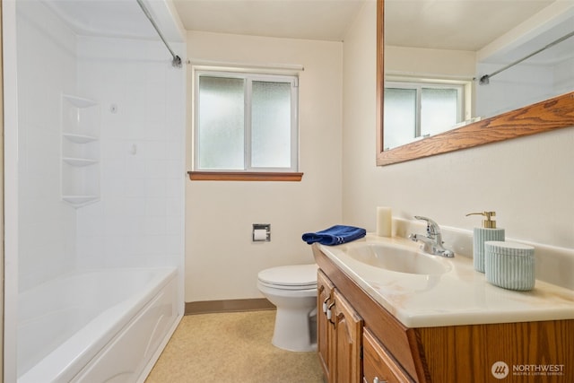 bathroom with tub / shower combination, toilet, vanity, and baseboards