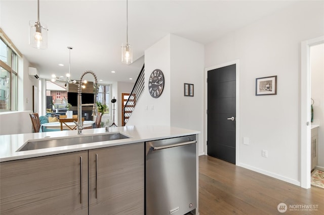 kitchen featuring dark wood finished floors, modern cabinets, open floor plan, light countertops, and stainless steel dishwasher