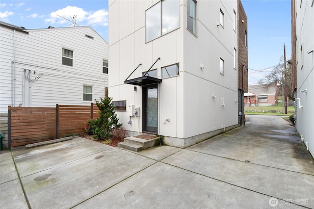 rear view of house with fence