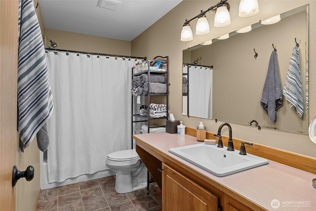 full bathroom with toilet and vanity