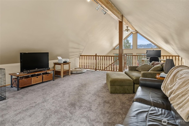 living room with a ceiling fan, rail lighting, carpet flooring, and lofted ceiling with beams