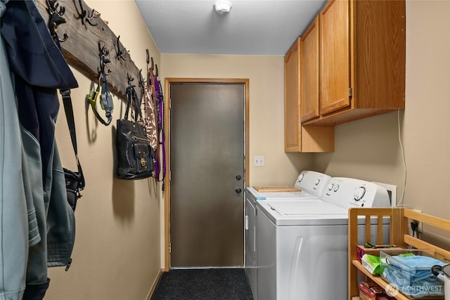 laundry area with cabinet space, baseboards, and washer and dryer