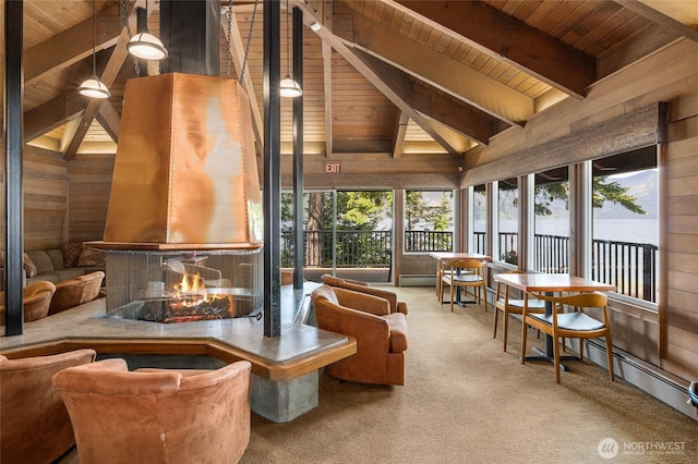 sunroom / solarium featuring vaulted ceiling with beams, wood ceiling, and a multi sided fireplace