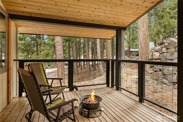 unfurnished sunroom featuring wooden ceiling