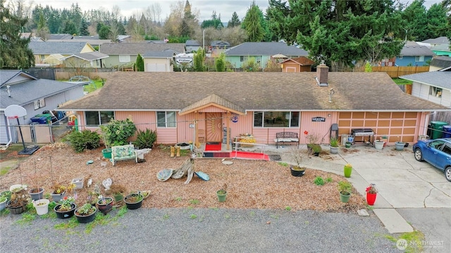 ranch-style home with driveway, a residential view, fence, and a chimney