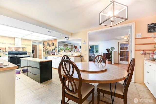 dining space with light tile patterned floors and a chandelier