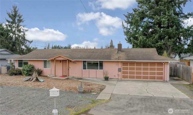 ranch-style house with fence, roof with shingles, concrete driveway, an attached garage, and a chimney