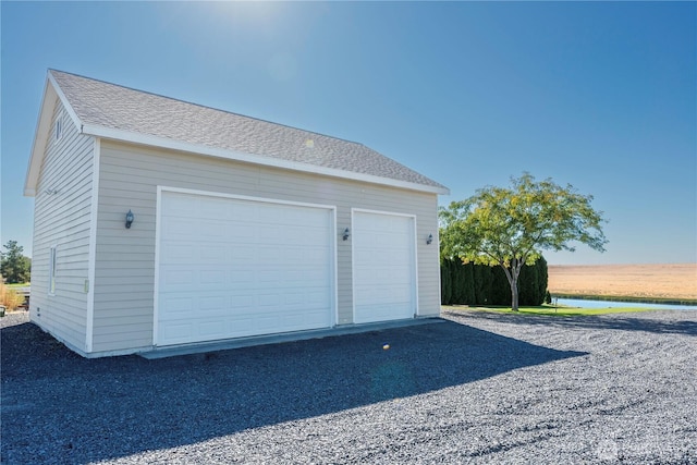 detached garage with a water view