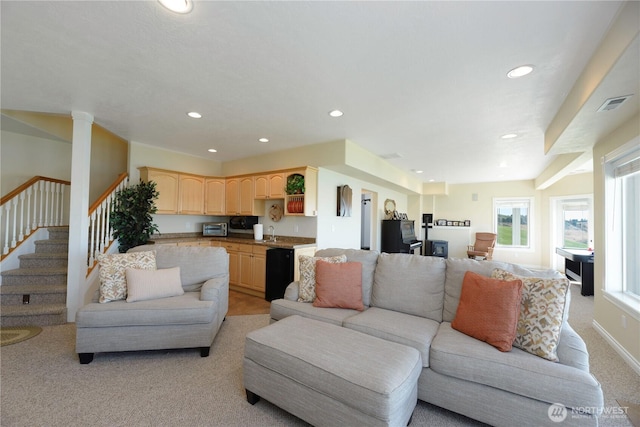 living area with a toaster, recessed lighting, visible vents, light carpet, and stairs