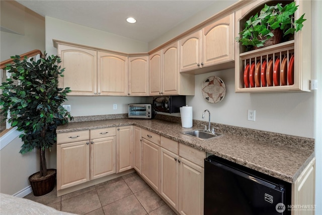 kitchen with light tile patterned floors, a toaster, a sink, dishwasher, and light brown cabinetry