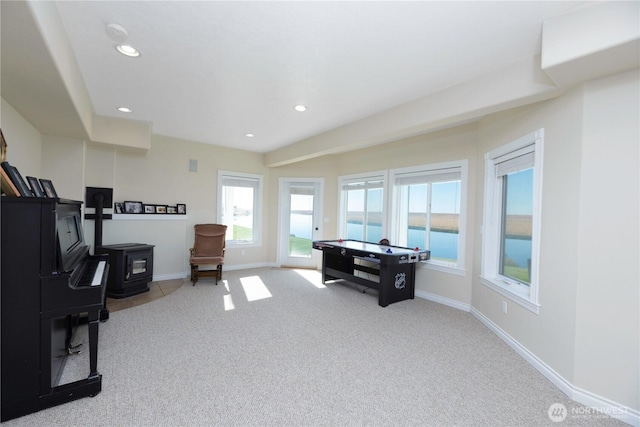 office space with recessed lighting, carpet, a wood stove, and baseboards