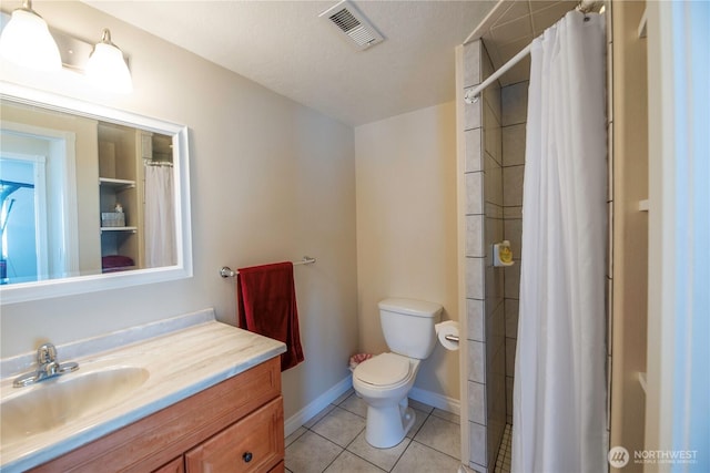 bathroom featuring baseboards, visible vents, toilet, tile patterned floors, and vanity