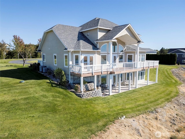 9486 NE Stonecrest Rd, Moses Lake, WA 98837 - rear view of house with a patio area, roof with shingles, and a lawn