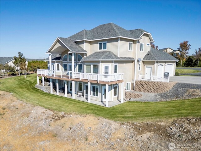 9486 NE Stonecrest Rd, Moses Lake, WA 98837 - rear view of house with driveway, a yard, a patio area, and a garage