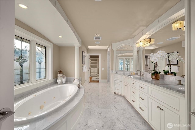full bath with a wealth of natural light, marble finish floor, a sink, and decorative columns